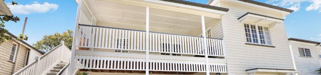 White balcony with railings and porch posts